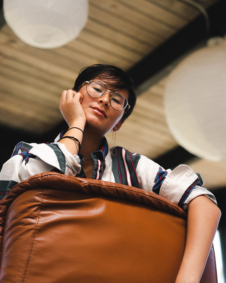 Woman looking over recliner back