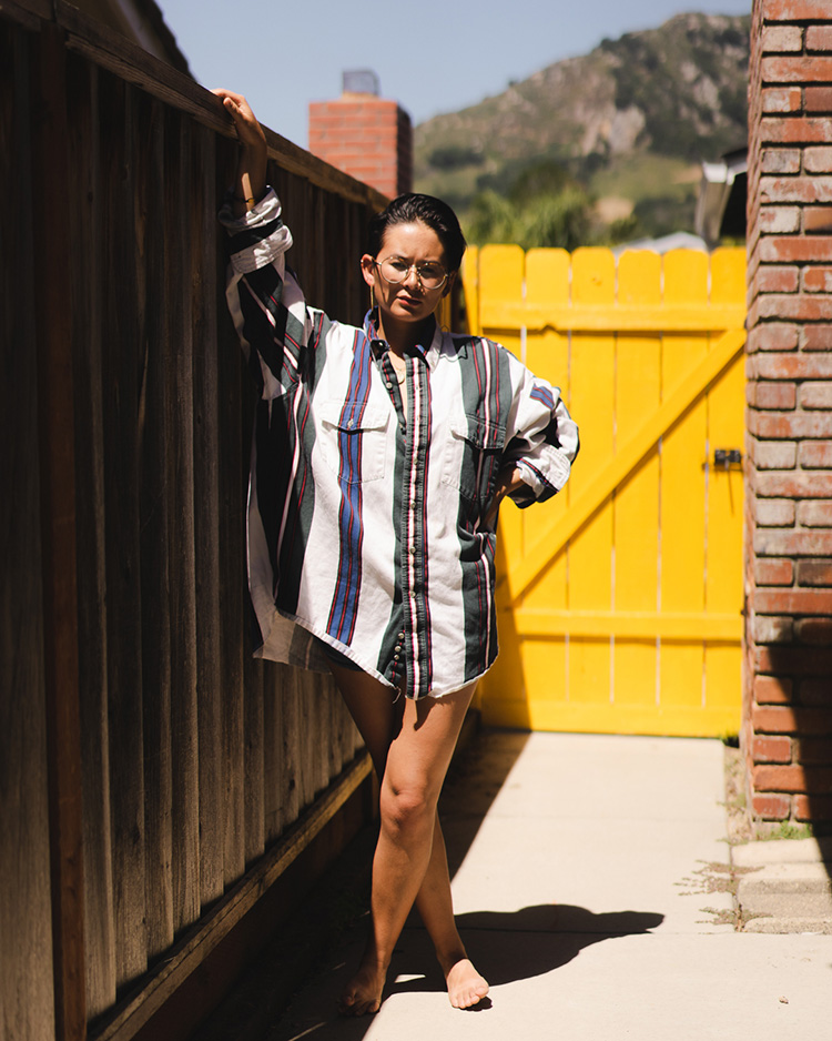Woman leaning against backyard fence