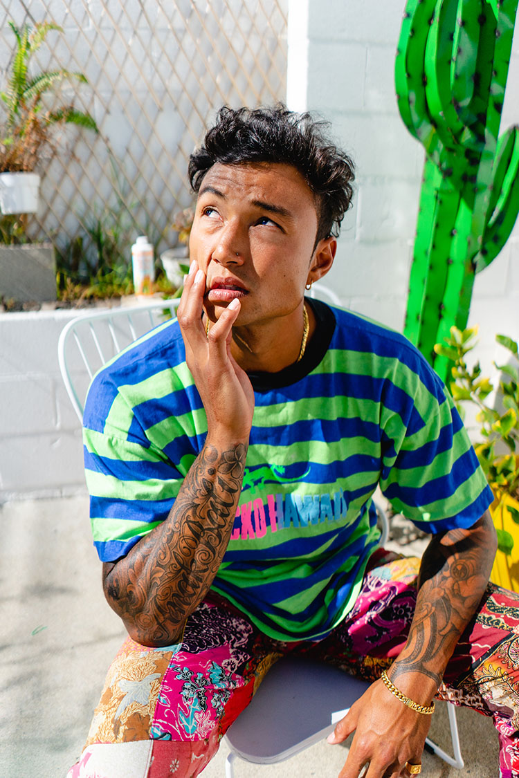 Man in colorful clothes stares into the sun